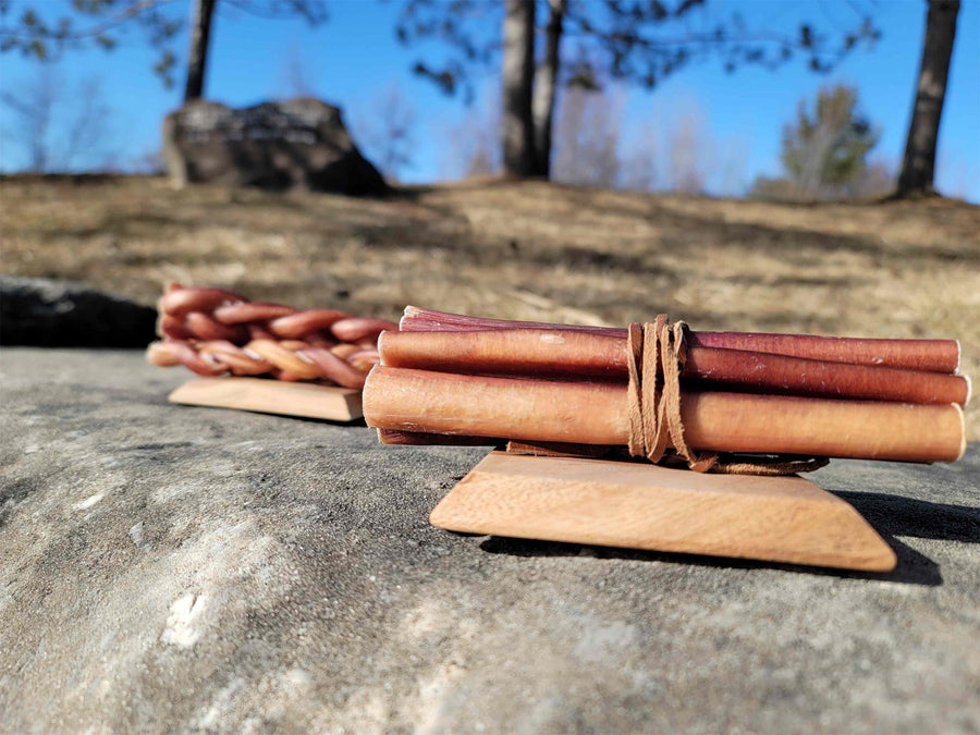 PUPHE straight and braided bully sticks side by side on wooden boards